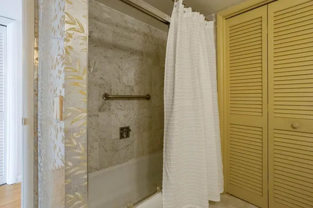 a kitchen with a sink and a stove top oven with wooden floor