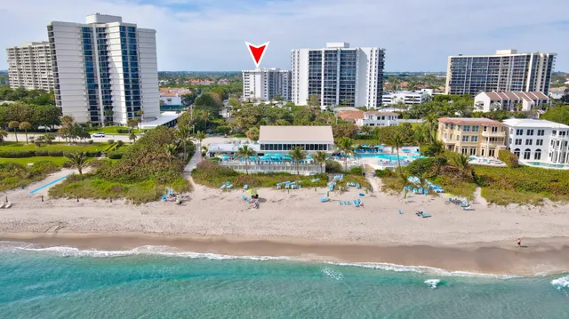 a sign that is sitting in front of a house with a big yard