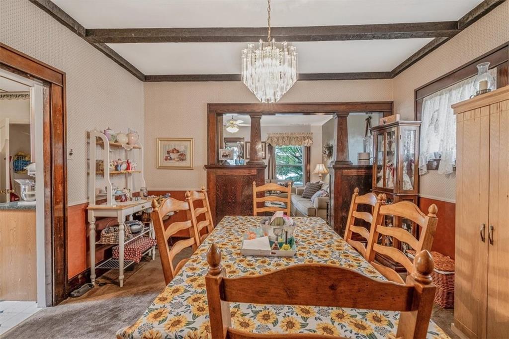 306 Meadow Avenue Charleroi, PA 15022 - Photo 11 of 36 a view of a dining room with furniture a chandelier and wooden floor