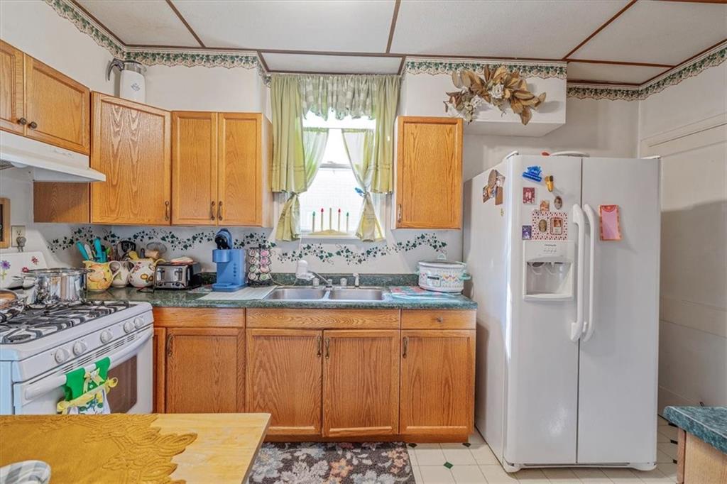 306 Meadow Avenue Charleroi, PA 15022 - Photo 12 of 36 a kitchen with stainless steel appliances a refrigerator and a stove