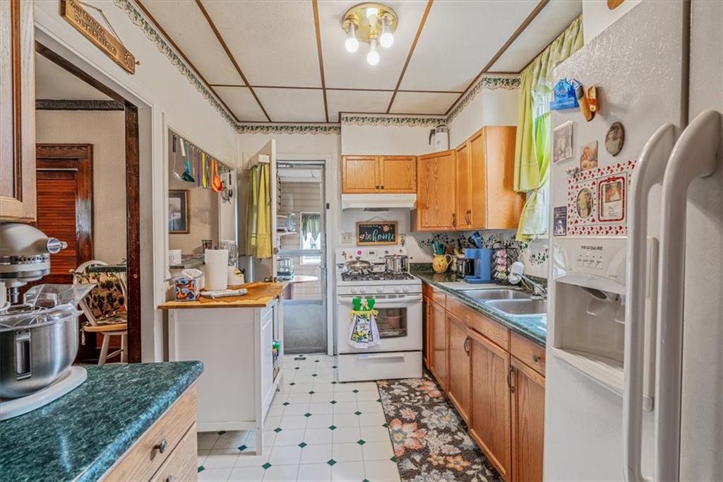 306 Meadow Avenue Charleroi, PA 15022 - Photo 13 of 36 a kitchen with stainless steel appliances kitchen island granite countertop a refrigerator and a stove