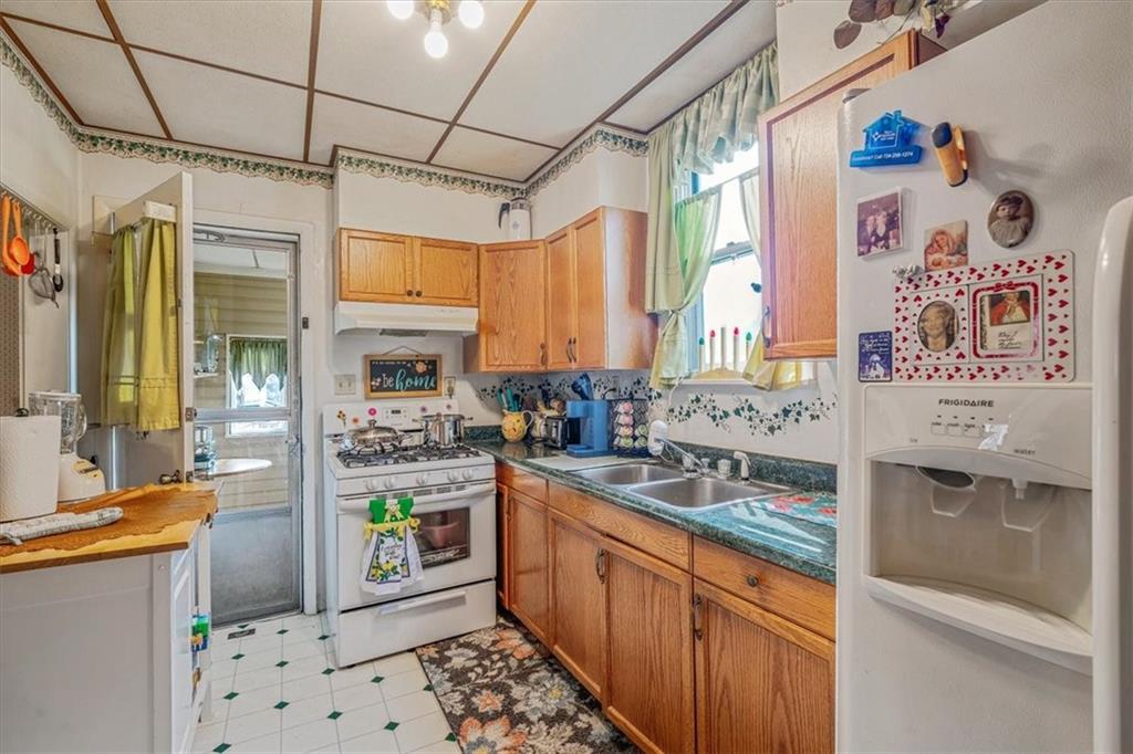 306 Meadow Avenue Charleroi, PA 15022 - Photo 14 of 36 a kitchen with stainless steel appliances granite countertop a sink and a refrigerator