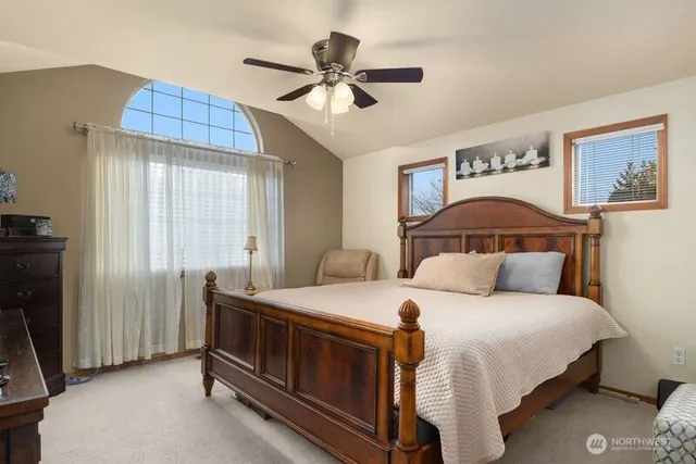 a bedroom with a bed and a ceiling fan
