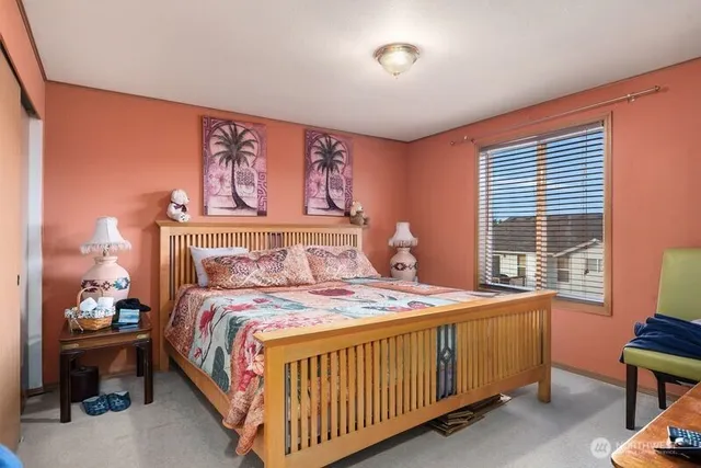 a bedroom with a bed and window