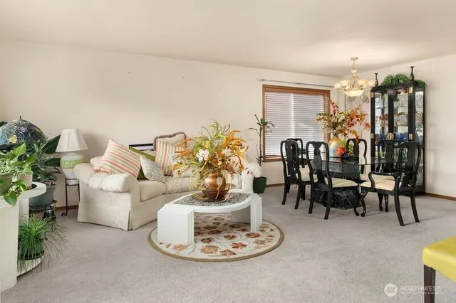 a living room with furniture and flowers