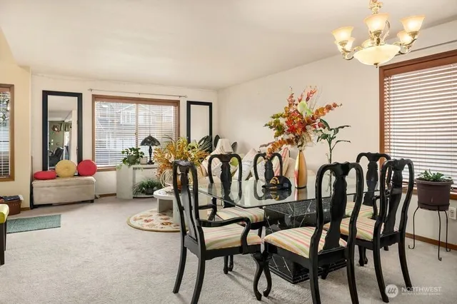 a view of a dining room with furniture and a chandelier