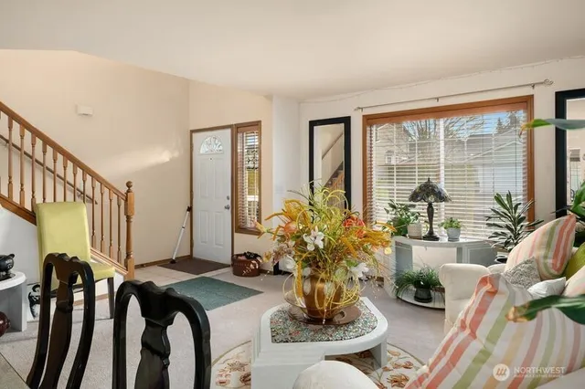 a living room with furniture and floor to ceiling windows