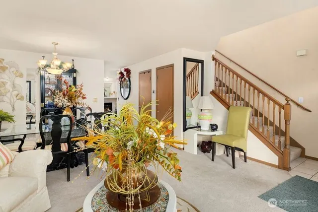 a living room with furniture and a chandelier