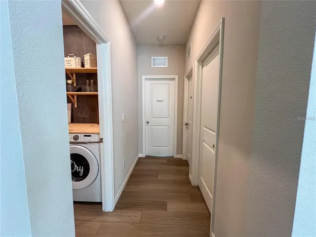 a view of a hallway with washer and dryer