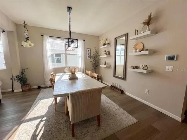 a view of a dining room with furniture window and wooden floor