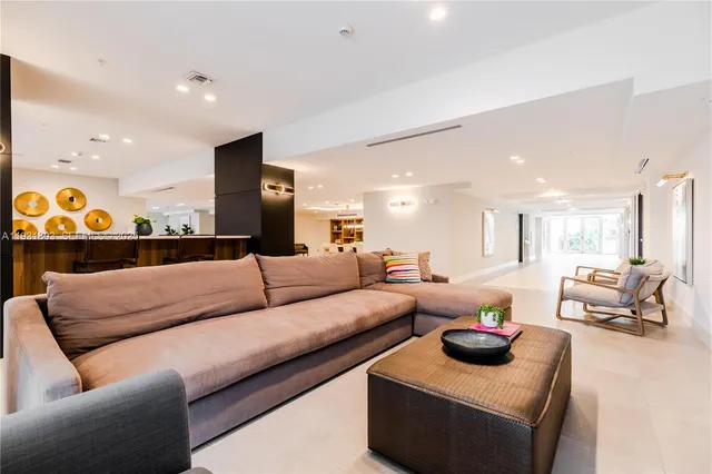 a living room with furniture and a lamp