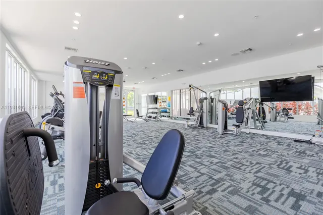 a view of a living room with furniture and a flat screen tv