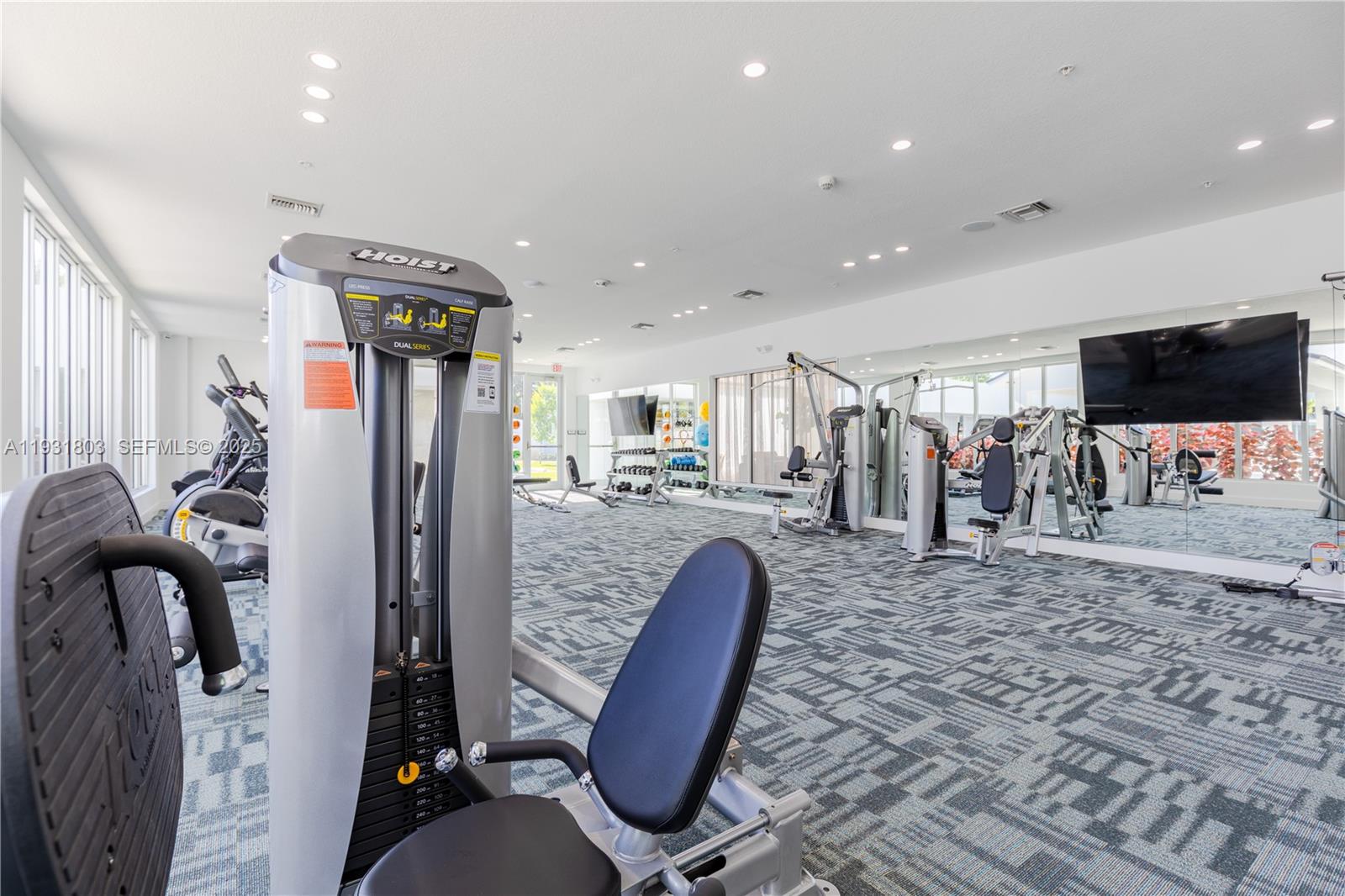 1950 West 49th Street, Unit 148 Hialeah, FL 33012 - Photo 30 of 39 a view of a living room with furniture and a flat screen tv