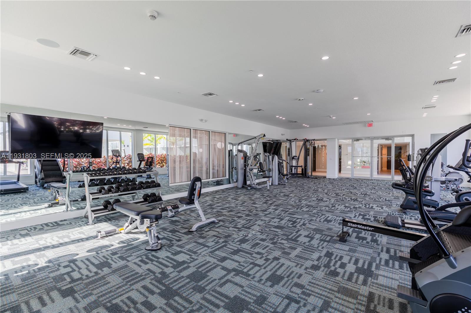1950 West 49th Street, Unit 148 Hialeah, FL 33012 - Photo 34 of 39 a living room with furniture and a flat screen tv