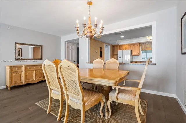 a living room with furniture chandelier and window