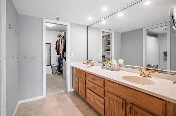 a kitchen with a sink cabinets stainless steel appliances and a window