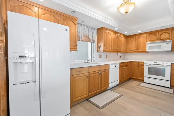 a view of kitchen and utility room with washer and dryer