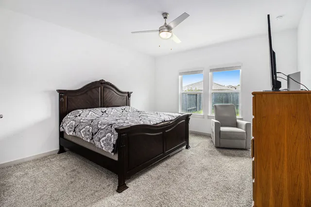 a bedroom with a bed couch and window
