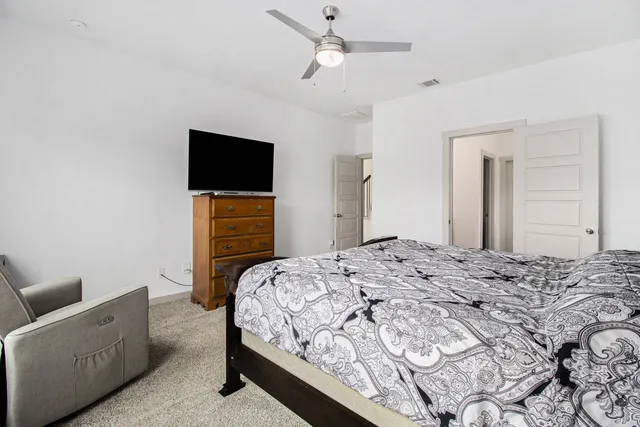 a bedroom with a bed and a television