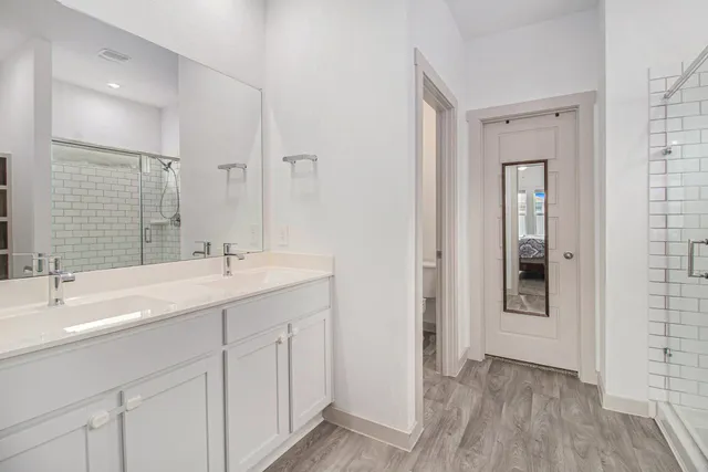 a bathroom with a double vanity sink and mirror