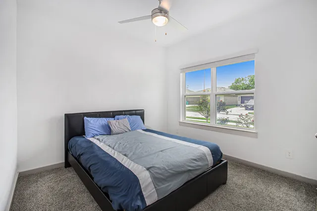 a bedroom with a bed and a window