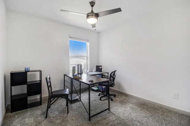 a view of a workspace with furniture