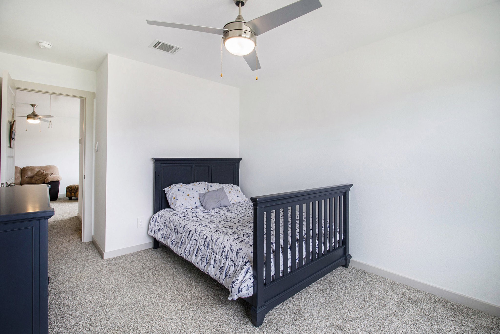 1823 William Scott Street Baytown, TX 77523 - Photo 24 of 27 a bedroom with a bed and a chandelier
