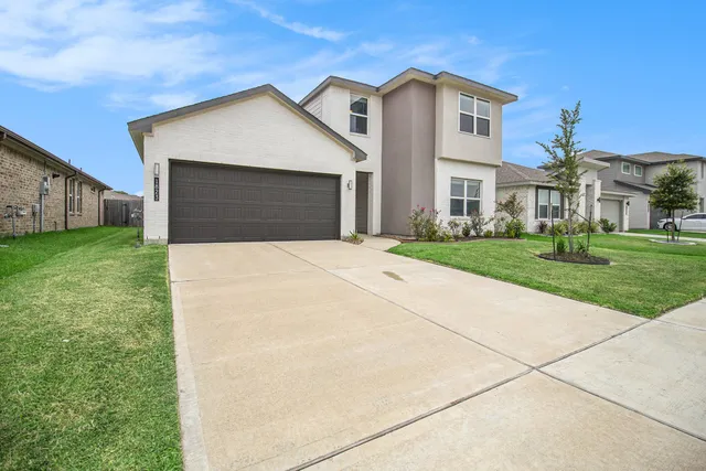 a front view of a house with yard