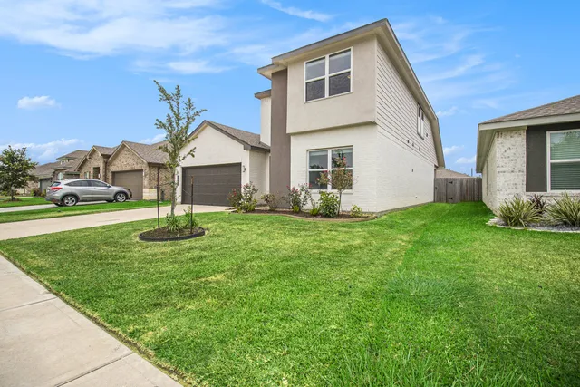 a front view of house with yard and green space