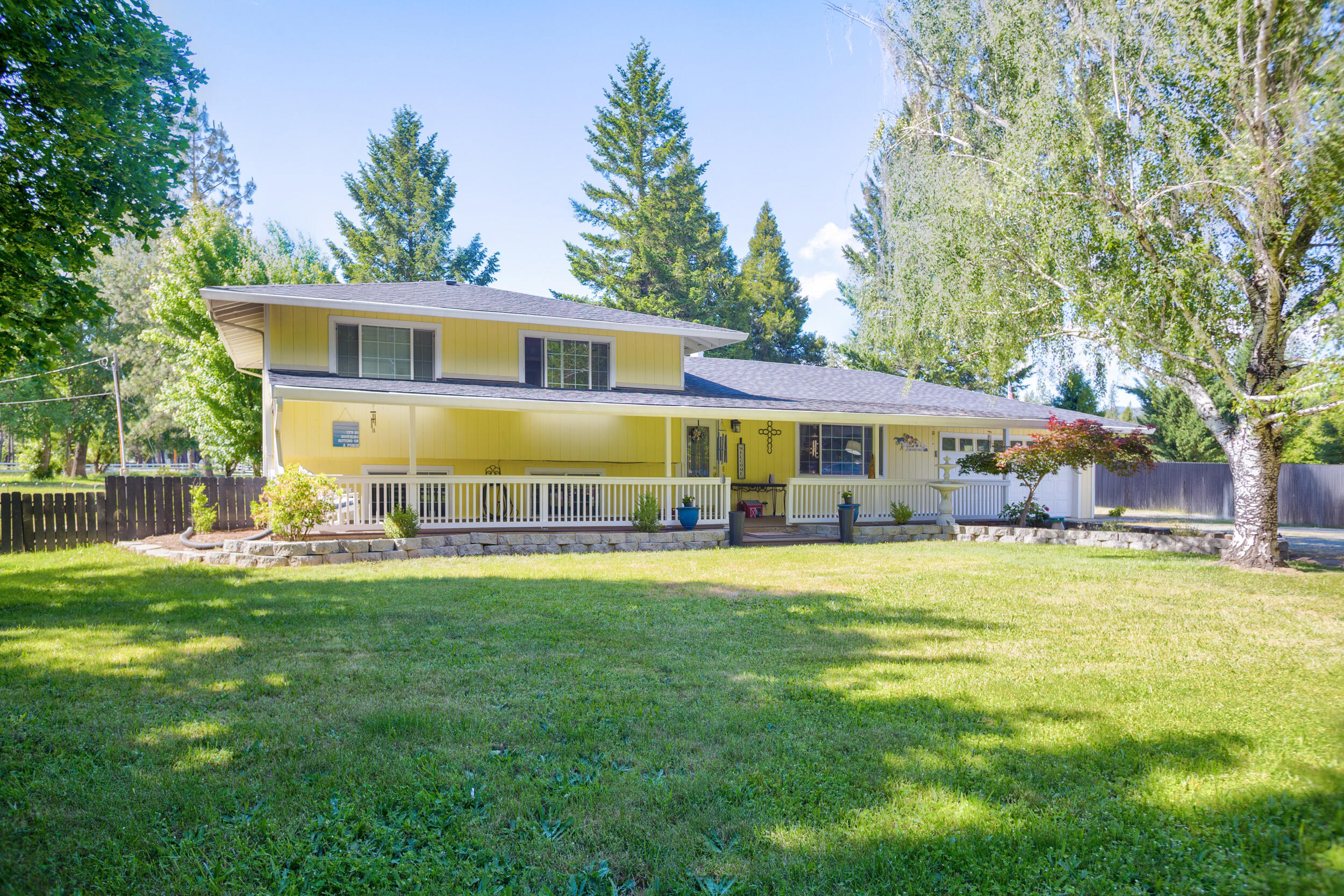255 Queens Branch Road Rogue River, OR 97537 - Photo 1 of 60 a front view of a house with a garden