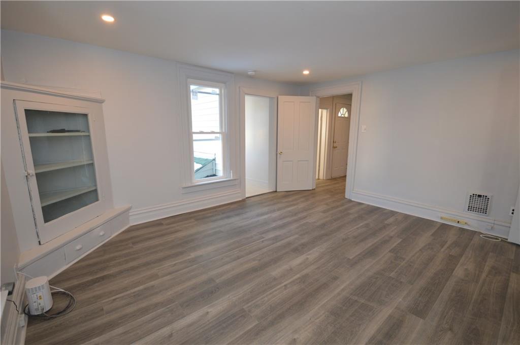 115 Meade Avenue Pittsburgh, PA 15202 - Photo 12 of 38 an empty room with wooden floor and windows