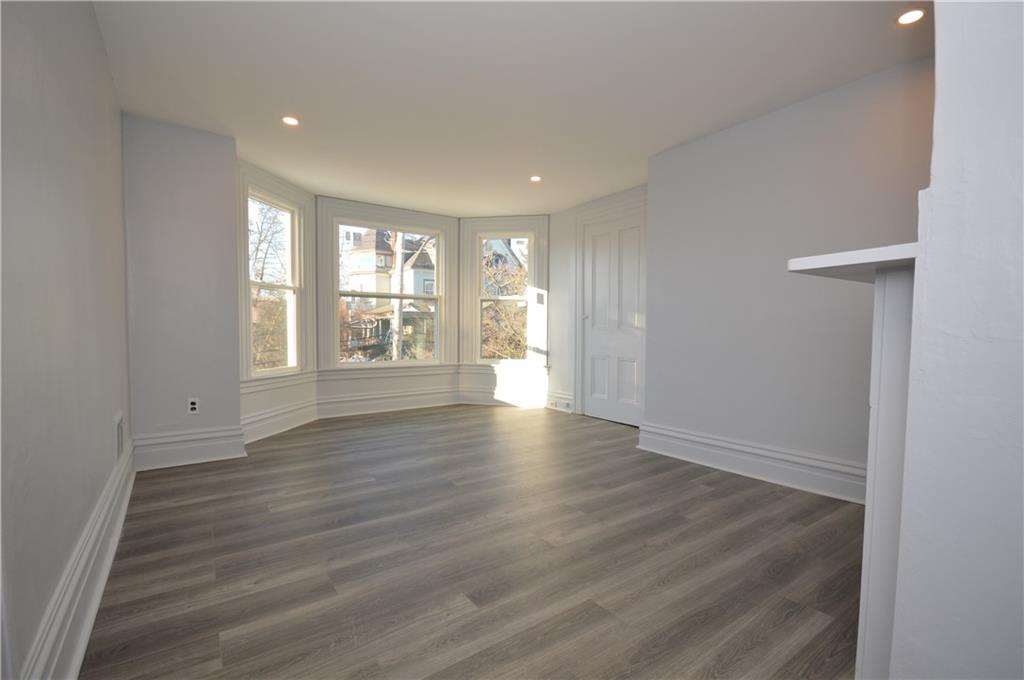 115 Meade Avenue Pittsburgh, PA 15202 - Photo 14 of 38 a view of an empty room with wooden floor and a window