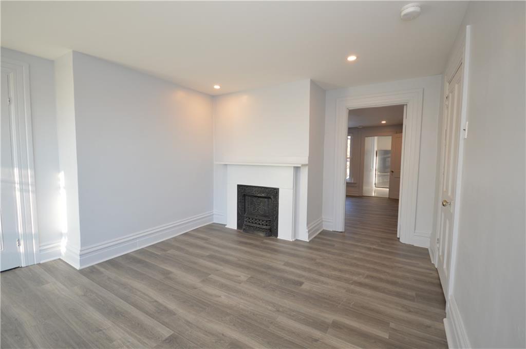 115 Meade Avenue Pittsburgh, PA 15202 - Photo 15 of 38 a view of a livingroom with wooden floor and a fireplace
