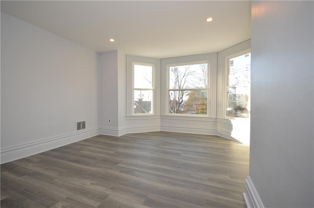 115 Meade Avenue Pittsburgh, PA 15202 - Photo 16 of 38 a view of an empty room with wooden floor and a window