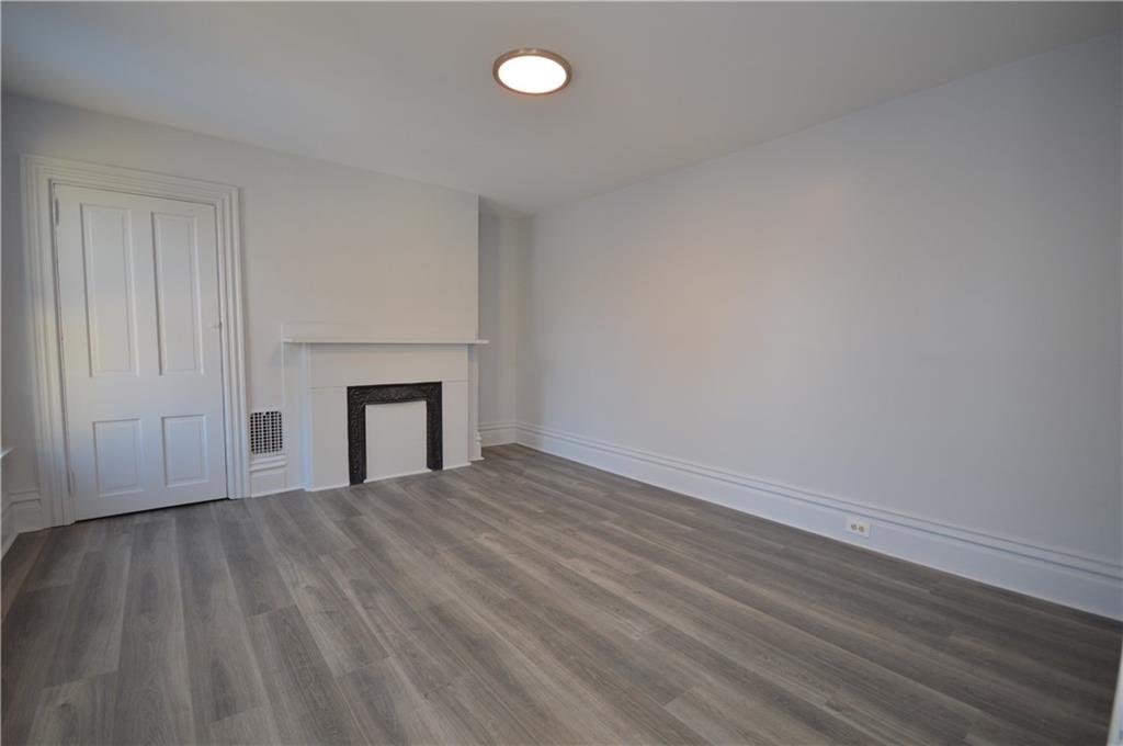115 Meade Avenue Pittsburgh, PA 15202 - Photo 21 of 38 a view of an empty room with wooden floor and a window