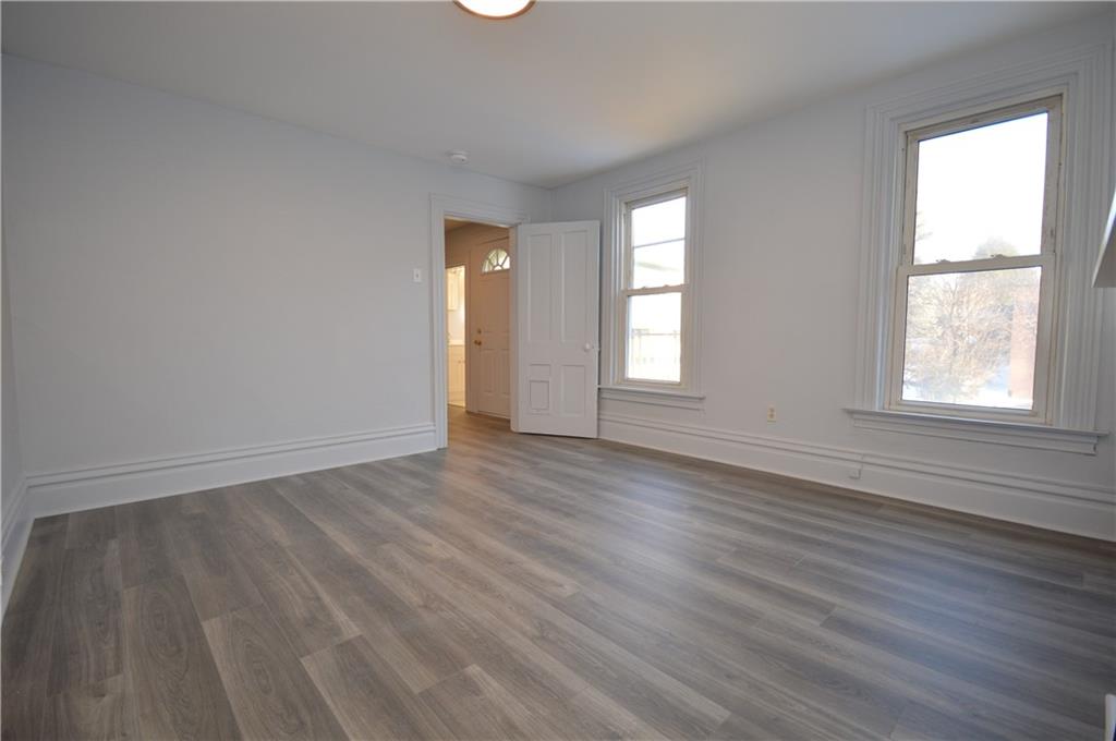 115 Meade Avenue Pittsburgh, PA 15202 - Photo 23 of 38 an empty room with wooden floor and windows
