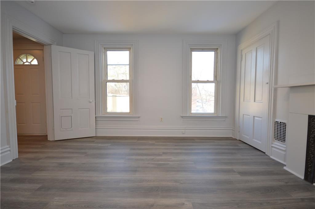 115 Meade Avenue Pittsburgh, PA 15202 - Photo 24 of 38 an empty room with wooden floor and windows