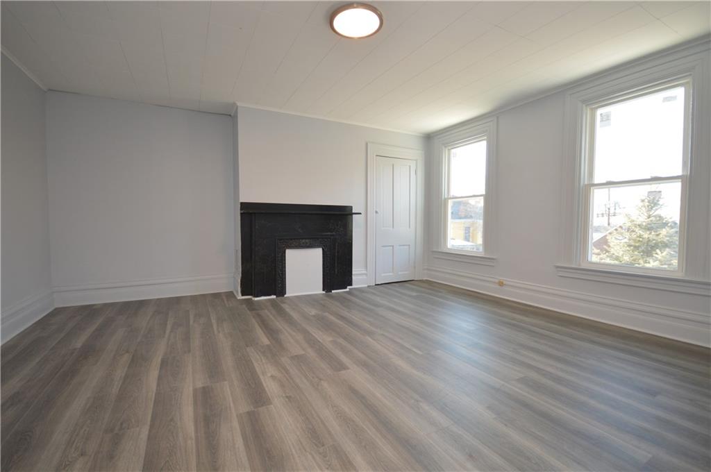 115 Meade Avenue Pittsburgh, PA 15202 - Photo 26 of 38 an empty room with windows and fireplace