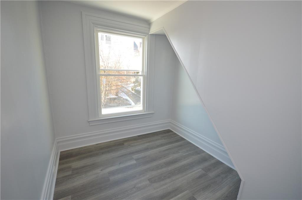 115 Meade Avenue Pittsburgh, PA 15202 - Photo 31 of 38 an empty room with wooden floor and windows