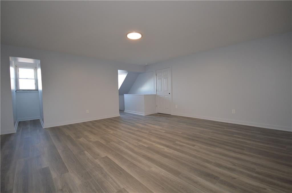 115 Meade Avenue Pittsburgh, PA 15202 - Photo 33 of 38 an empty room with wooden floor and windows
