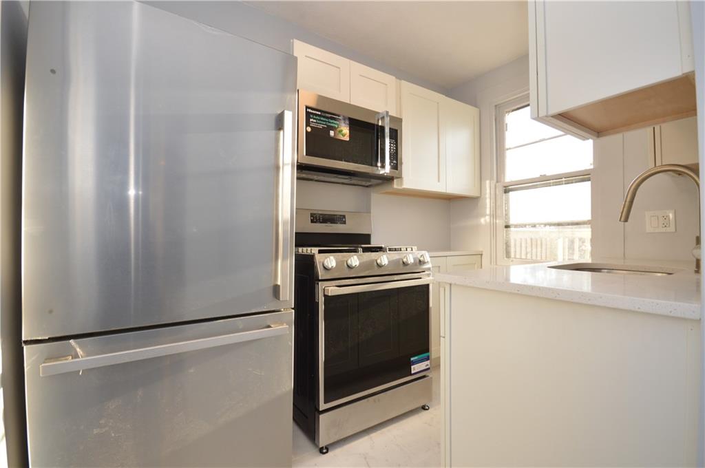 115 Meade Avenue Pittsburgh, PA 15202 - Photo 5 of 38 a kitchen with stainless steel appliances granite countertop a refrigerator and a sink