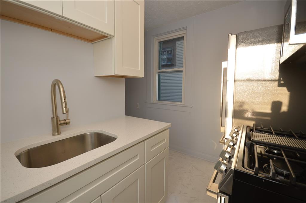 115 Meade Avenue Pittsburgh, PA 15202 - Photo 6 of 38 a kitchen with a sink and white cabinets