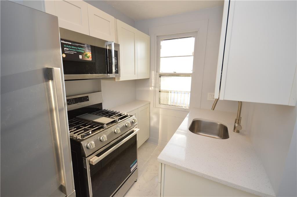 115 Meade Avenue Pittsburgh, PA 15202 - Photo 7 of 38 a kitchen with a stove and a microwave
