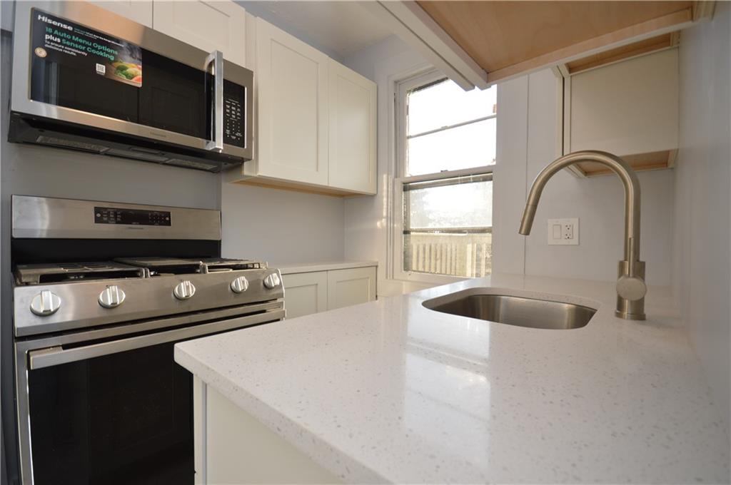 115 Meade Avenue Pittsburgh, PA 15202 - Photo 8 of 38 a kitchen with a stove and a microwave