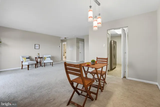 a dining room with furniture and chandelier