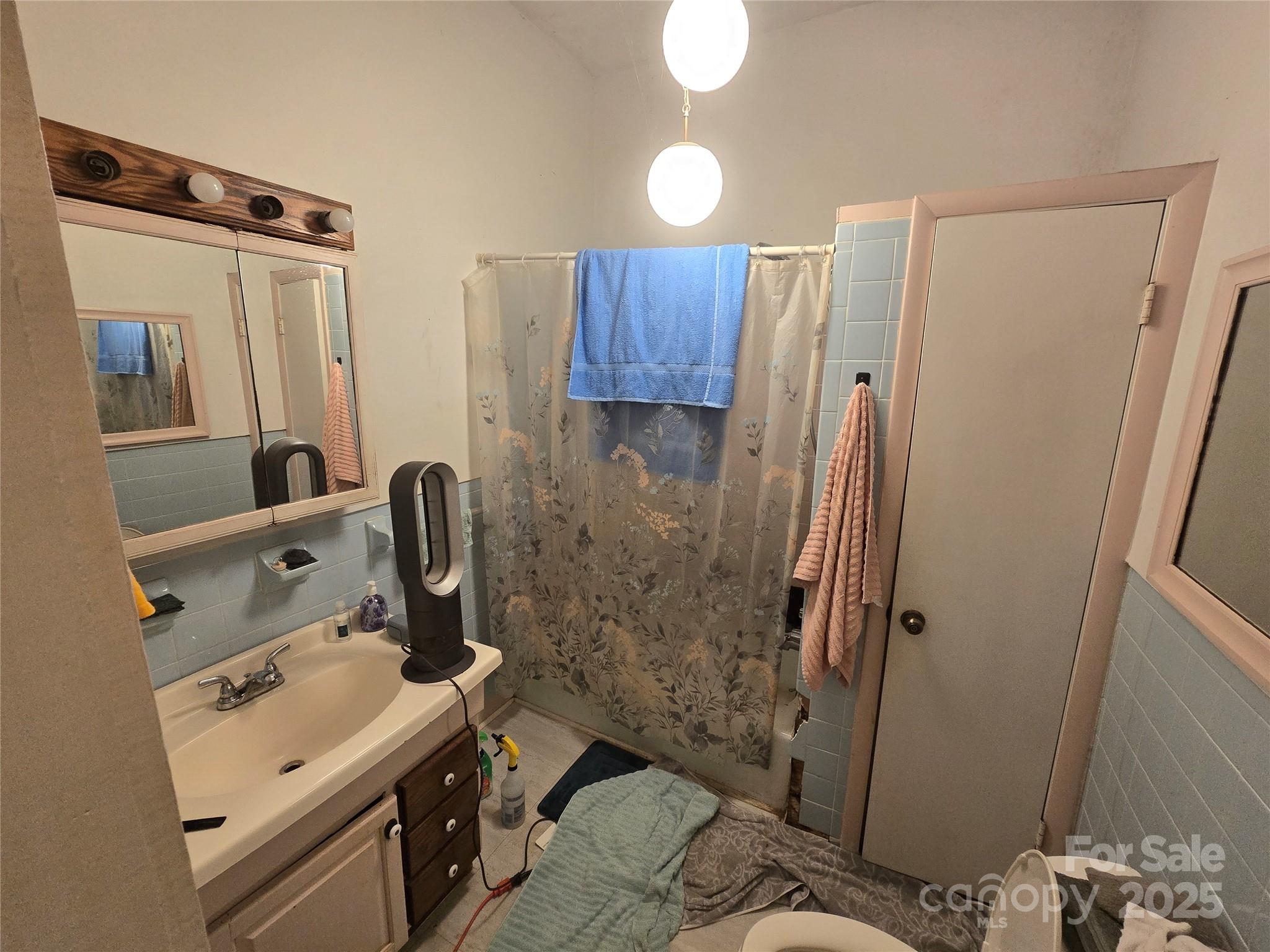509 5th Street, Unit 5 Spencer, NC 28159 - Photo 13 of 20 a bathroom with a sink toilet and shower