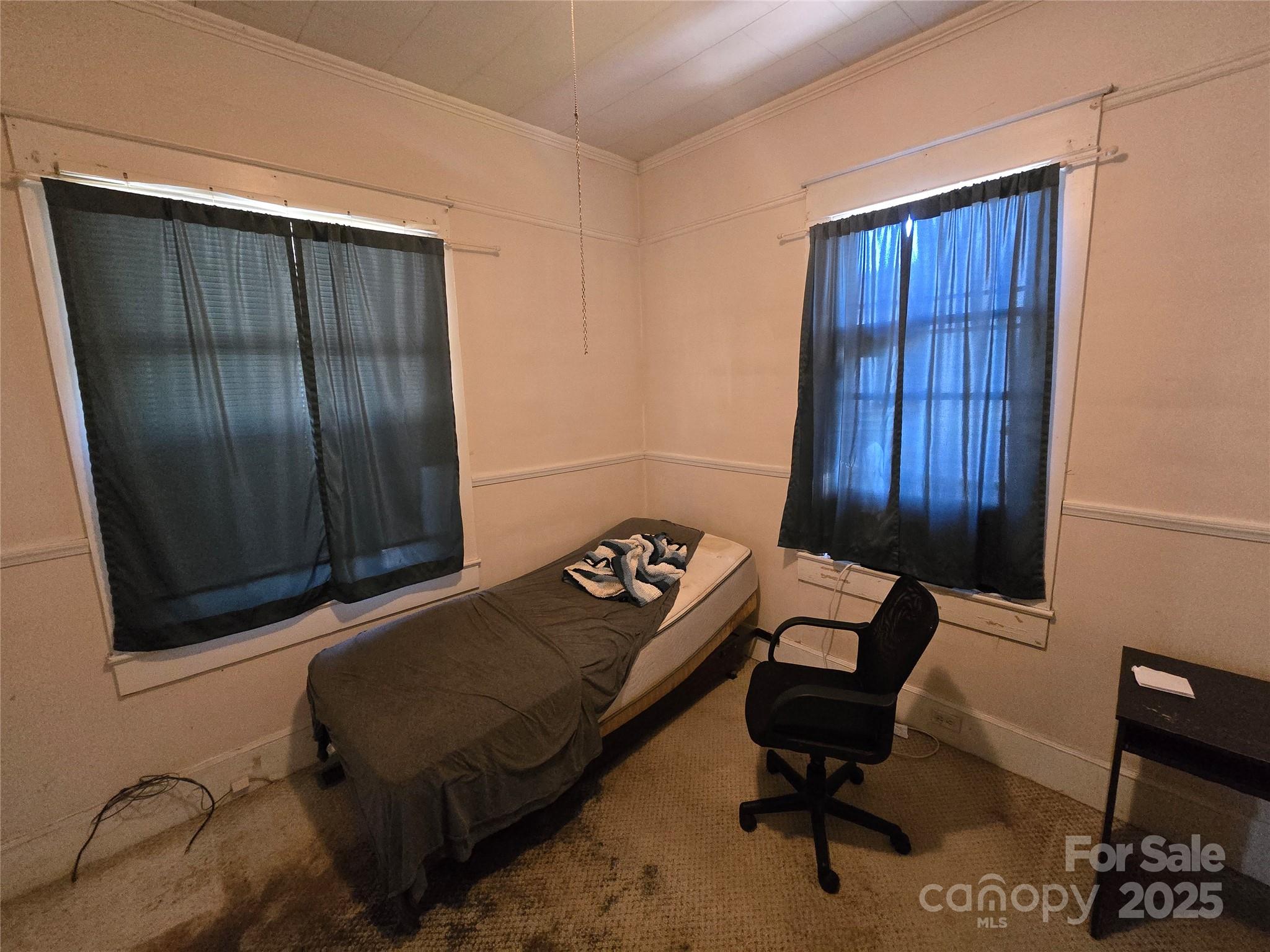 509 5th Street, Unit 5 Spencer, NC 28159 - Photo 19 of 20 a bedroom with a bed and chair