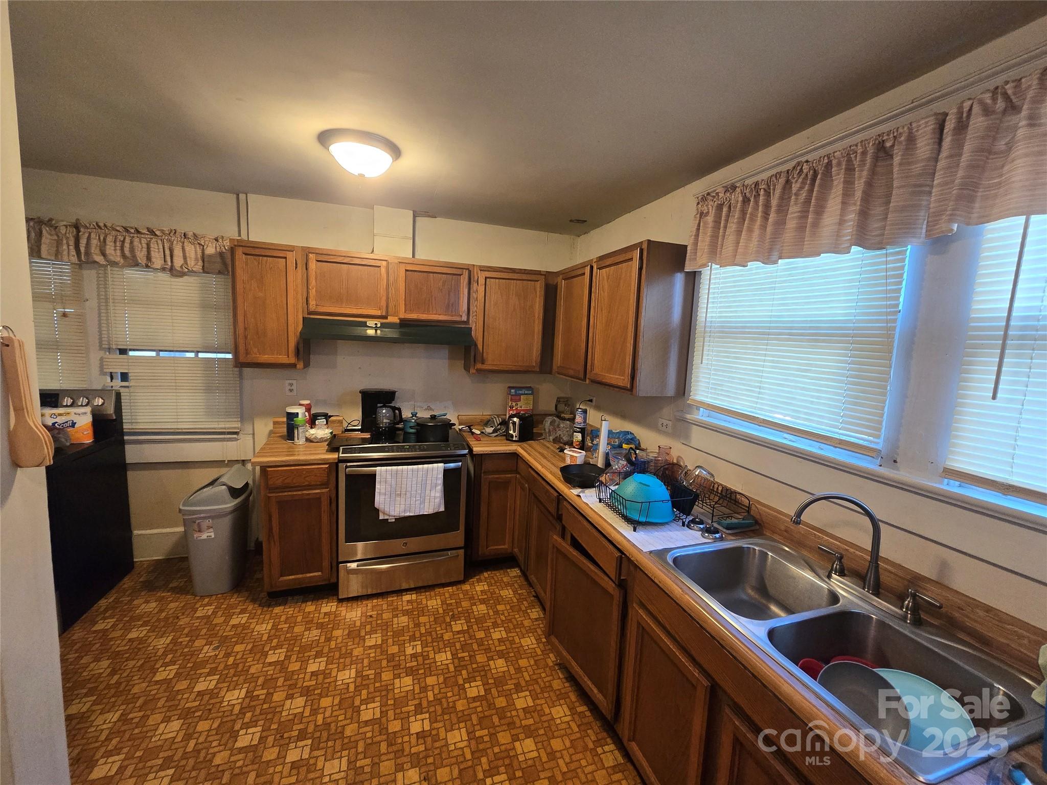 509 5th Street, Unit 5 Spencer, NC 28159 - Photo 9 of 20 a kitchen with sink cabinets stainless steel appliances and a window