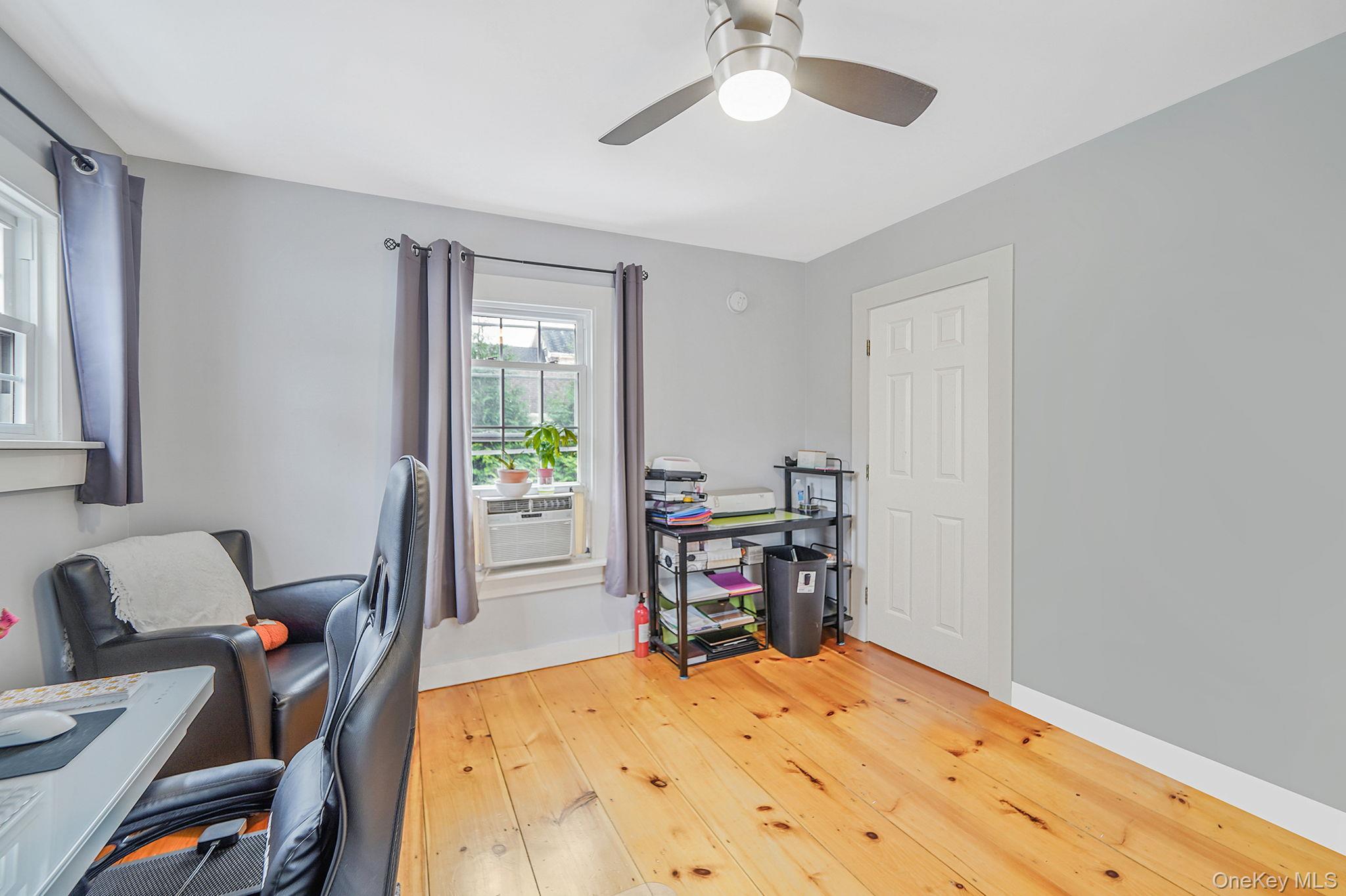 45 Maple Avenue Patchogue, NY 11772 - Photo 12 of 30 a bed room with a bed and a chair