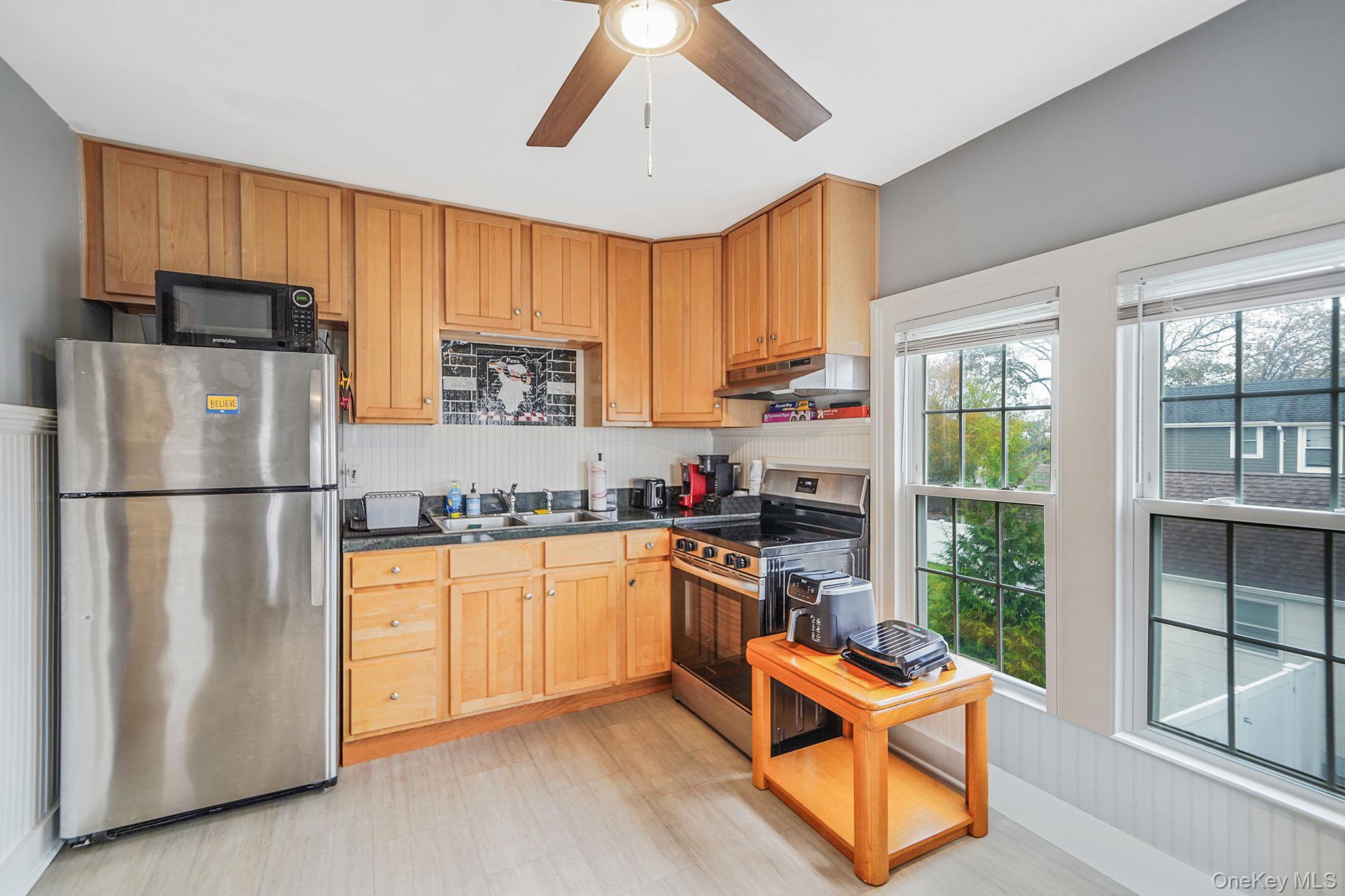 45 Maple Avenue Patchogue, NY 11772 - Photo 17 of 30 a kitchen with stainless steel appliances granite countertop a refrigerator stove top oven and sink